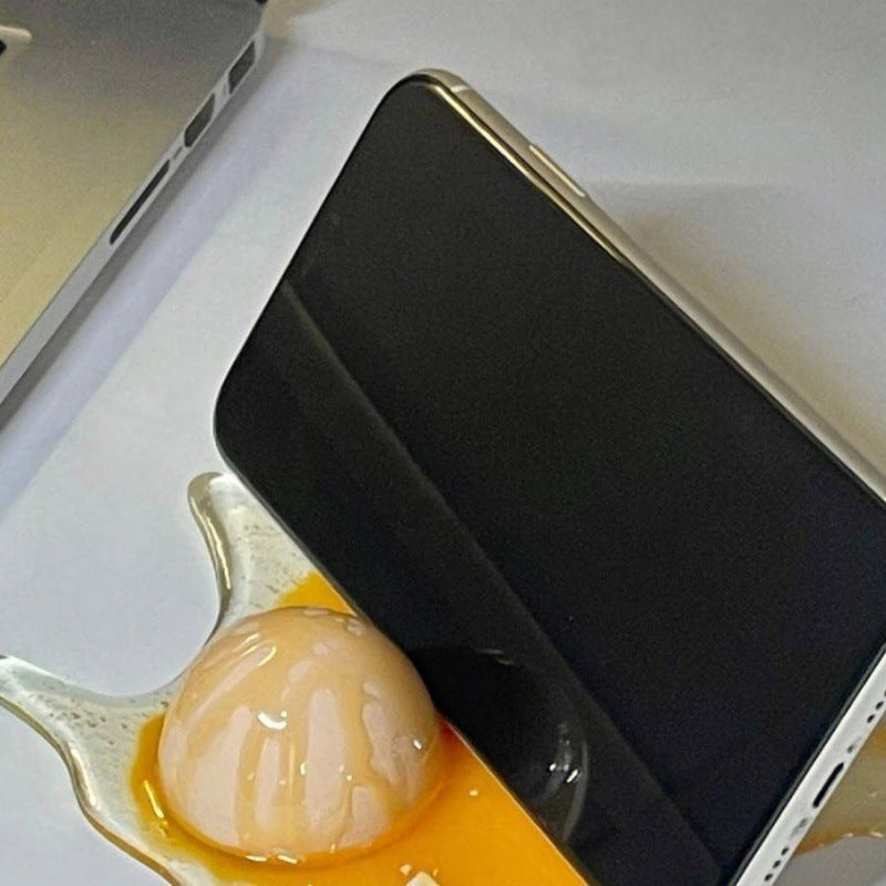 THEMEASHOP™ MAISON - Support de téléphone en forme d'œuf cassé - Jouet farce œuf cassé, thé au lait renversé